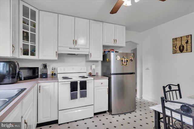 kitchen featuring white range with electric stovetop, ceiling fan, white cabinetry, and stainless steel refrigerator