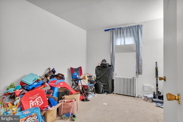 playroom featuring radiator and carpet