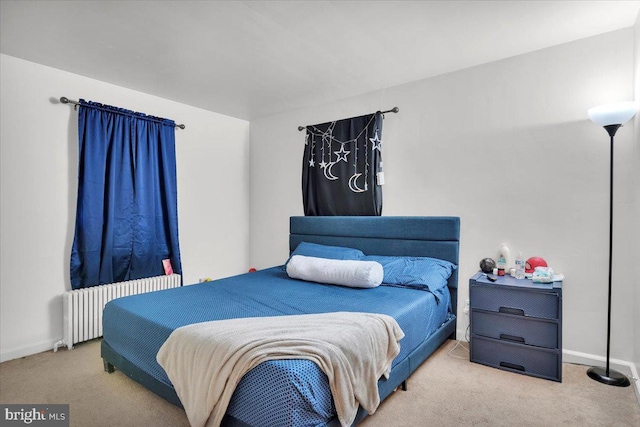 bedroom with radiator and light colored carpet