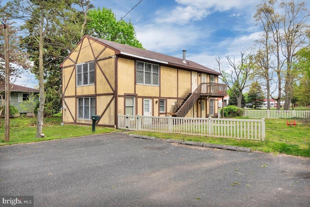 view of front facade featuring a front lawn and a deck