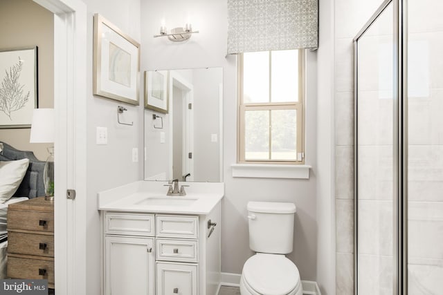 bathroom with vanity, toilet, and walk in shower