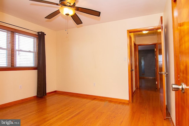 empty room featuring ceiling fan and light hardwood / wood-style flooring