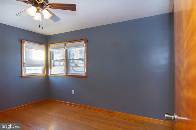 empty room featuring ceiling fan and hardwood / wood-style floors