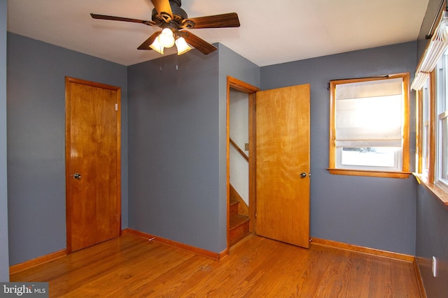 unfurnished bedroom featuring ceiling fan and light hardwood / wood-style flooring