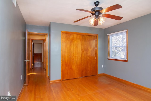 unfurnished bedroom featuring a closet, ceiling fan, and light hardwood / wood-style floors