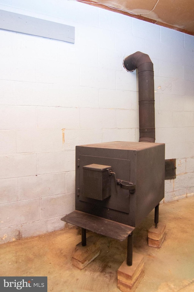 details featuring concrete floors and a wood stove