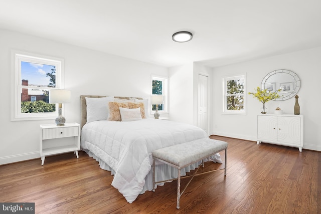 bedroom with hardwood / wood-style flooring