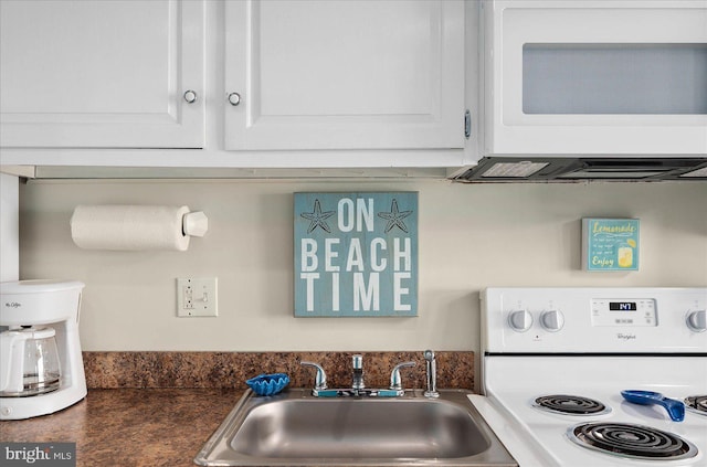 kitchen featuring sink, white cabinets, and white appliances