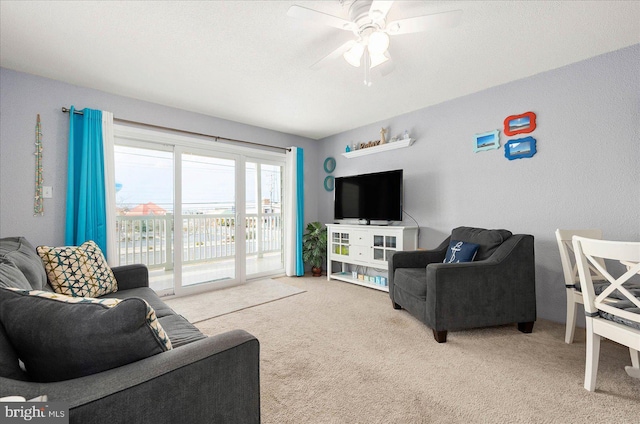 living room featuring carpet flooring and ceiling fan