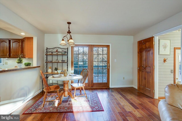 dining space with a chandelier and hardwood / wood-style flooring