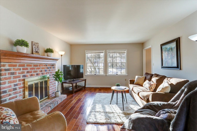 living room with a fireplace and dark hardwood / wood-style floors