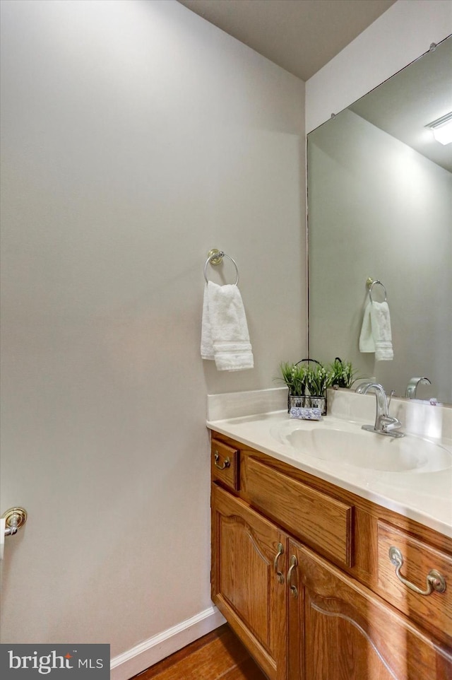 bathroom with vanity and hardwood / wood-style flooring