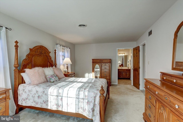 carpeted bedroom with ensuite bath