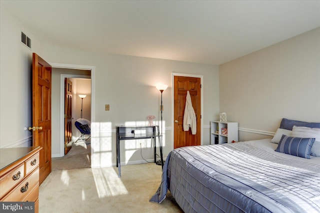 bedroom featuring light carpet and a closet