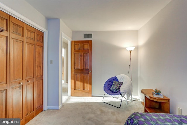 bedroom with light carpet and a closet