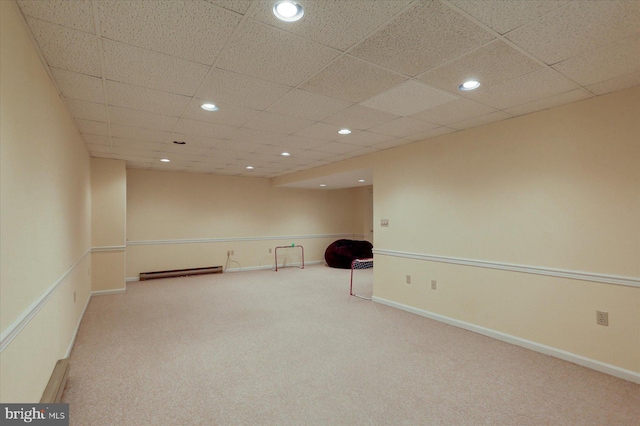 interior space featuring a paneled ceiling and baseboard heating