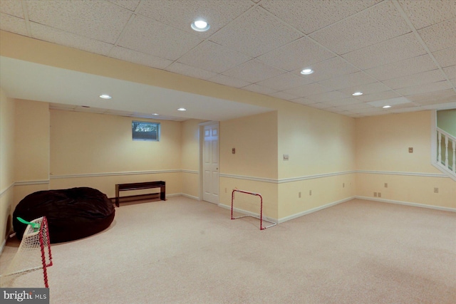 sitting room featuring carpet and a paneled ceiling