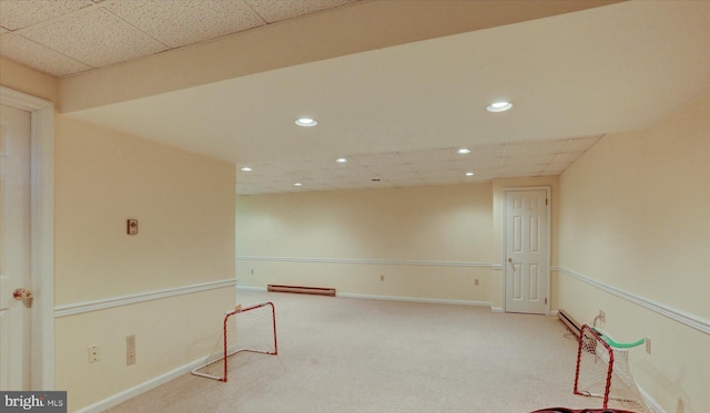 carpeted empty room featuring a paneled ceiling