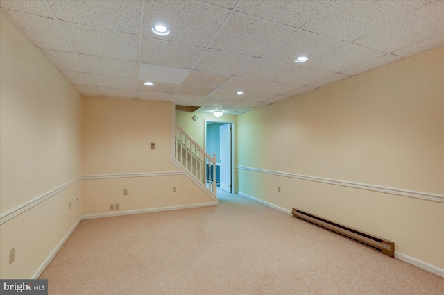 basement with carpet floors and a baseboard heating unit