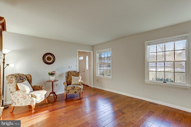 living area with hardwood / wood-style flooring