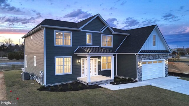 81 Filly Ln, Lewes, DE 19958 - view of front of house with driveway, a standing seam roof, a front yard, and metal roof