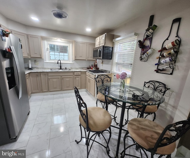 kitchen featuring backsplash, sink, plenty of natural light, and appliances with stainless steel finishes