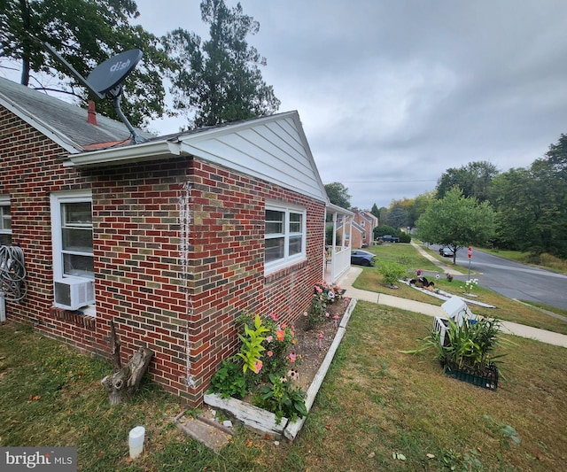 view of home's exterior featuring a yard and cooling unit