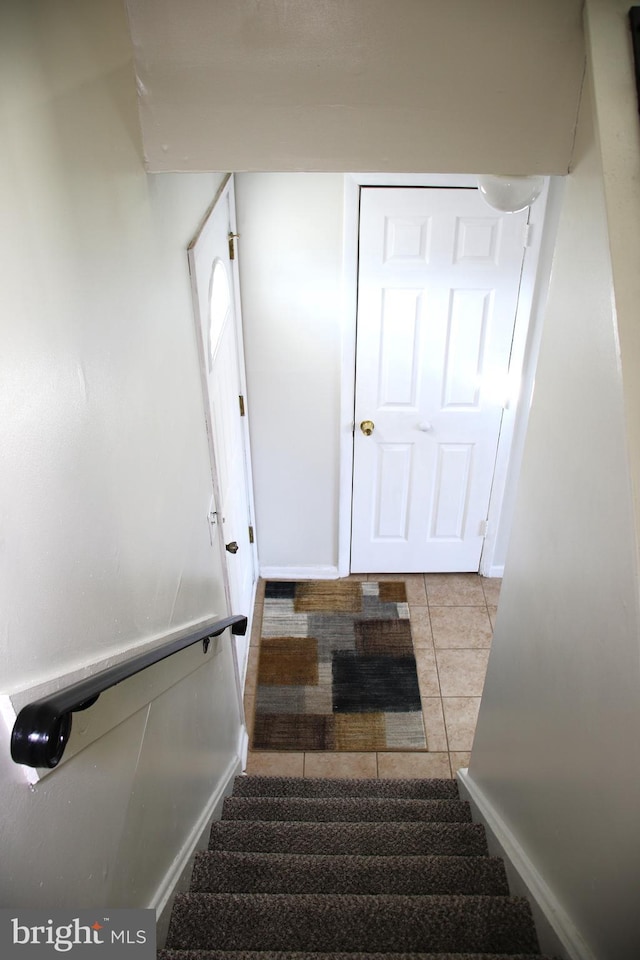 staircase with tile patterned flooring