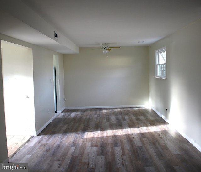 unfurnished room featuring ceiling fan and dark wood-type flooring