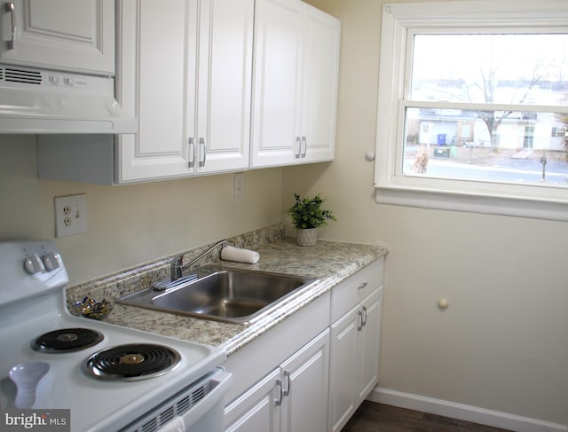 kitchen with white cabinetry, white electric range, light stone countertops, and sink