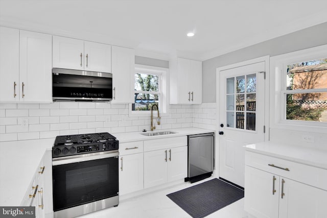 kitchen with sink, white cabinetry, decorative backsplash, range with gas cooktop, and stainless steel dishwasher