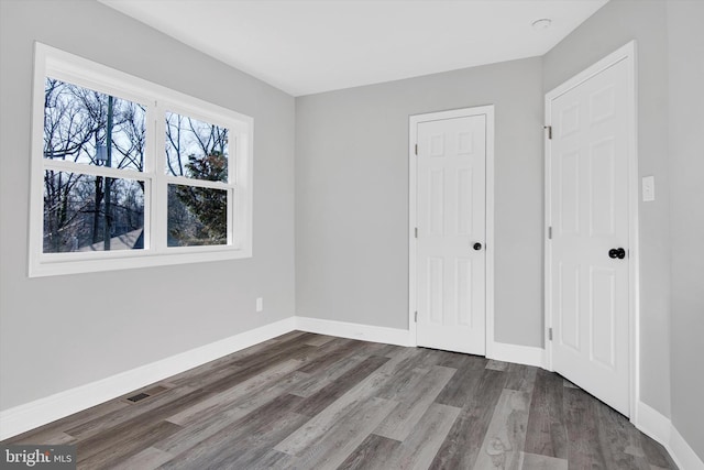 unfurnished bedroom featuring dark wood-type flooring