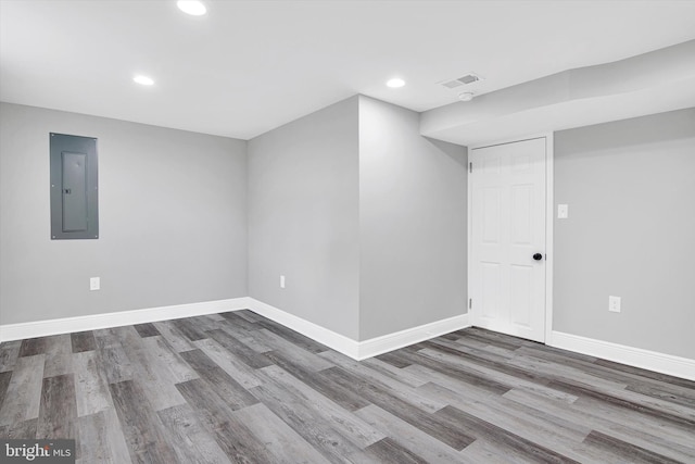 basement with wood-type flooring and electric panel