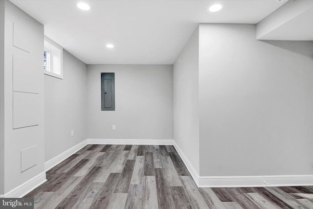 basement with hardwood / wood-style flooring and electric panel