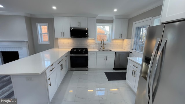 kitchen featuring appliances with stainless steel finishes, tasteful backsplash, sink, white cabinets, and kitchen peninsula