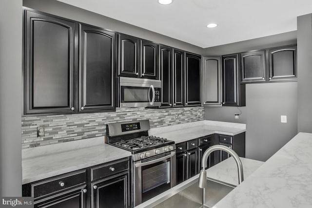 kitchen featuring light stone counters and appliances with stainless steel finishes