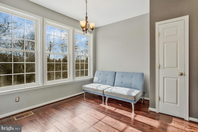 living area with a chandelier and hardwood / wood-style flooring