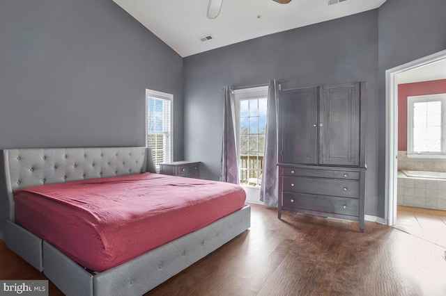 bedroom with hardwood / wood-style floors, ensuite bathroom, ceiling fan, and vaulted ceiling