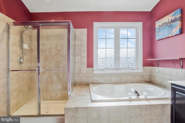 bathroom with vanity and separate shower and tub