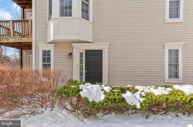 view of snow covered property entrance