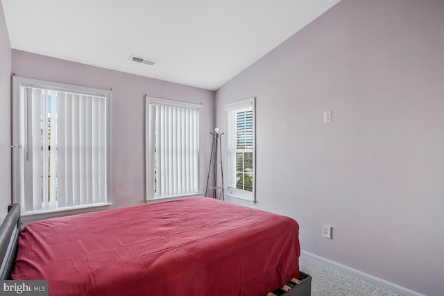 carpeted bedroom featuring lofted ceiling