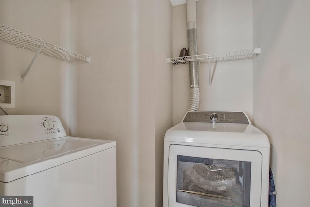 clothes washing area with independent washer and dryer