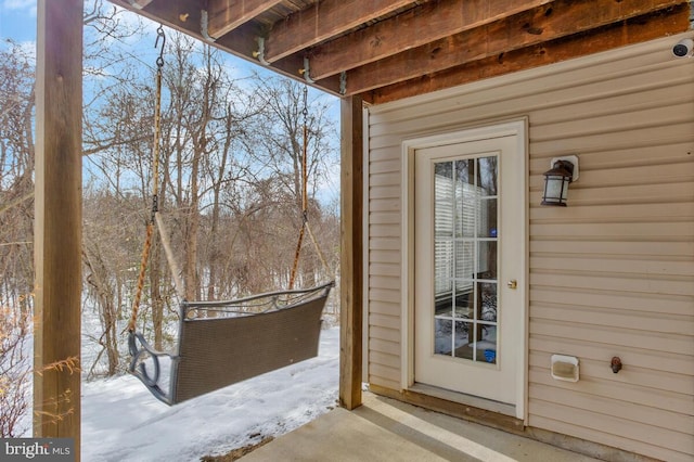 view of snow covered property entrance