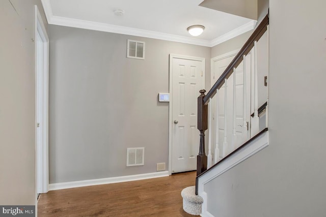 foyer with crown molding and wood-type flooring