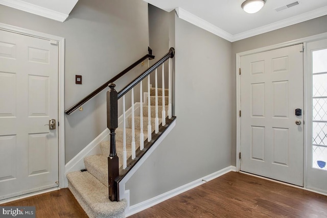 foyer featuring dark hardwood / wood-style floors and crown molding