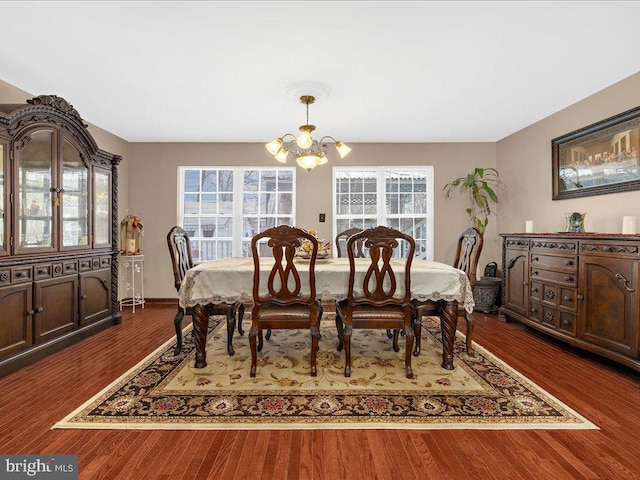 dining room featuring an inviting chandelier and dark hardwood / wood-style flooring