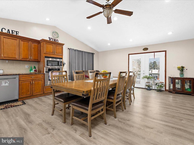 dining area featuring ceiling fan, light hardwood / wood-style flooring, french doors, and vaulted ceiling