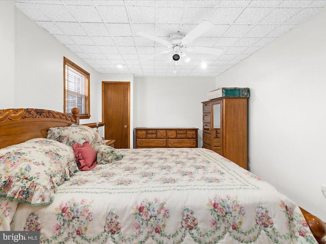 bedroom featuring ceiling fan and a paneled ceiling