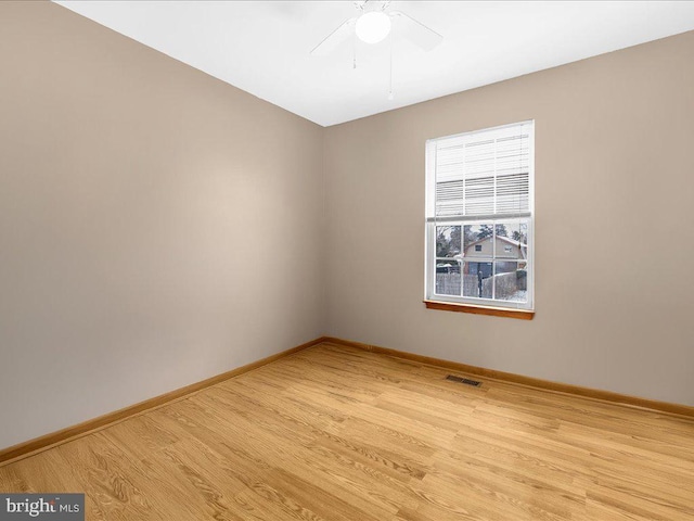 spare room with ceiling fan and light wood-type flooring