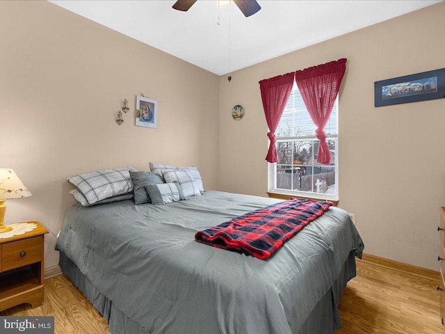 bedroom featuring light hardwood / wood-style floors and ceiling fan